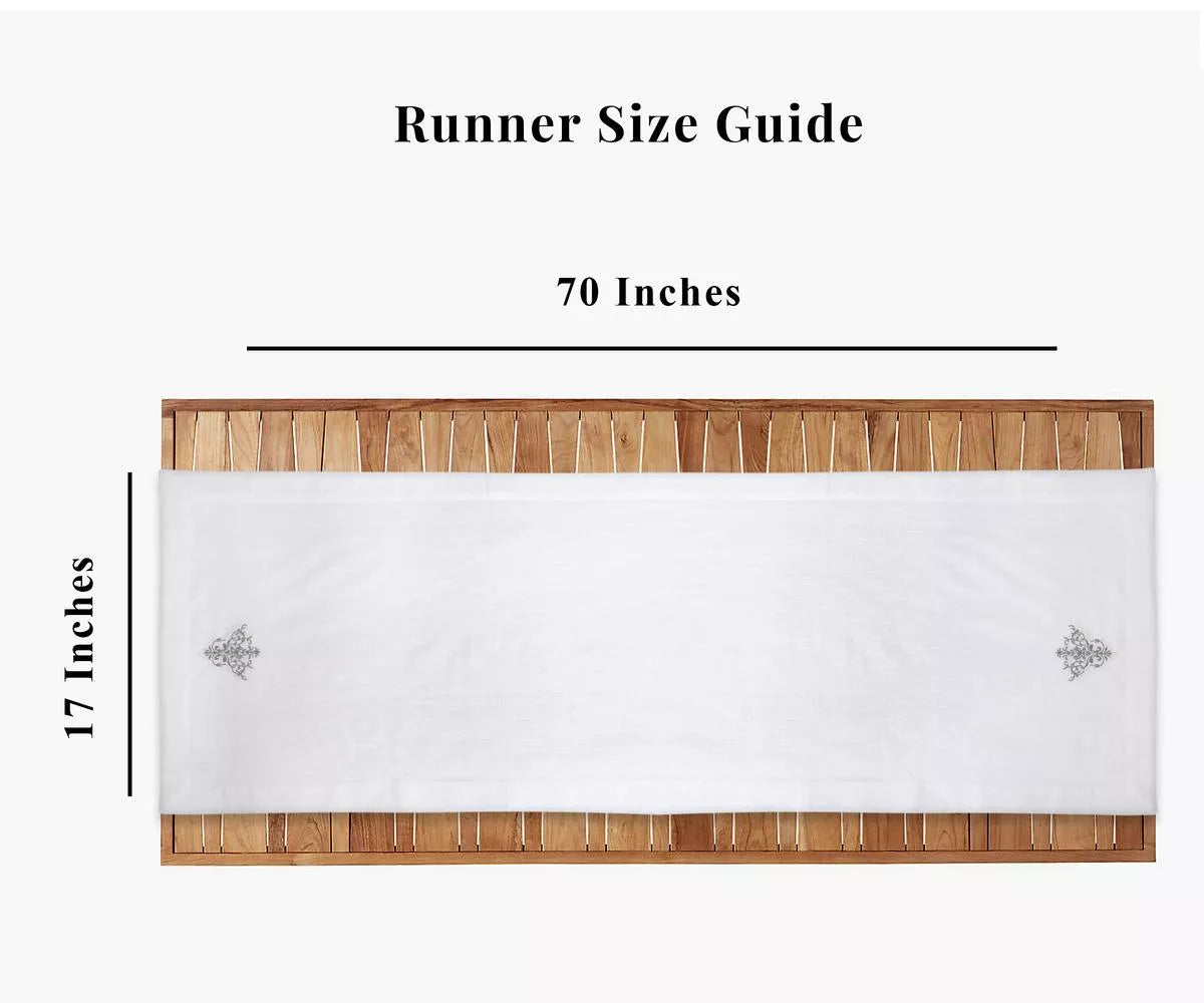 The white linen table runner is designed with an embroidery design. white table runner, dining table with a table runner.