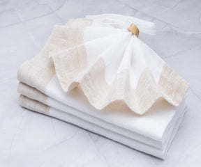 Crisp and pristine white linen napkins, offering a classic and sophisticated look for any occasion.