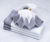 Soft linen dinner napkins displayed on dining table