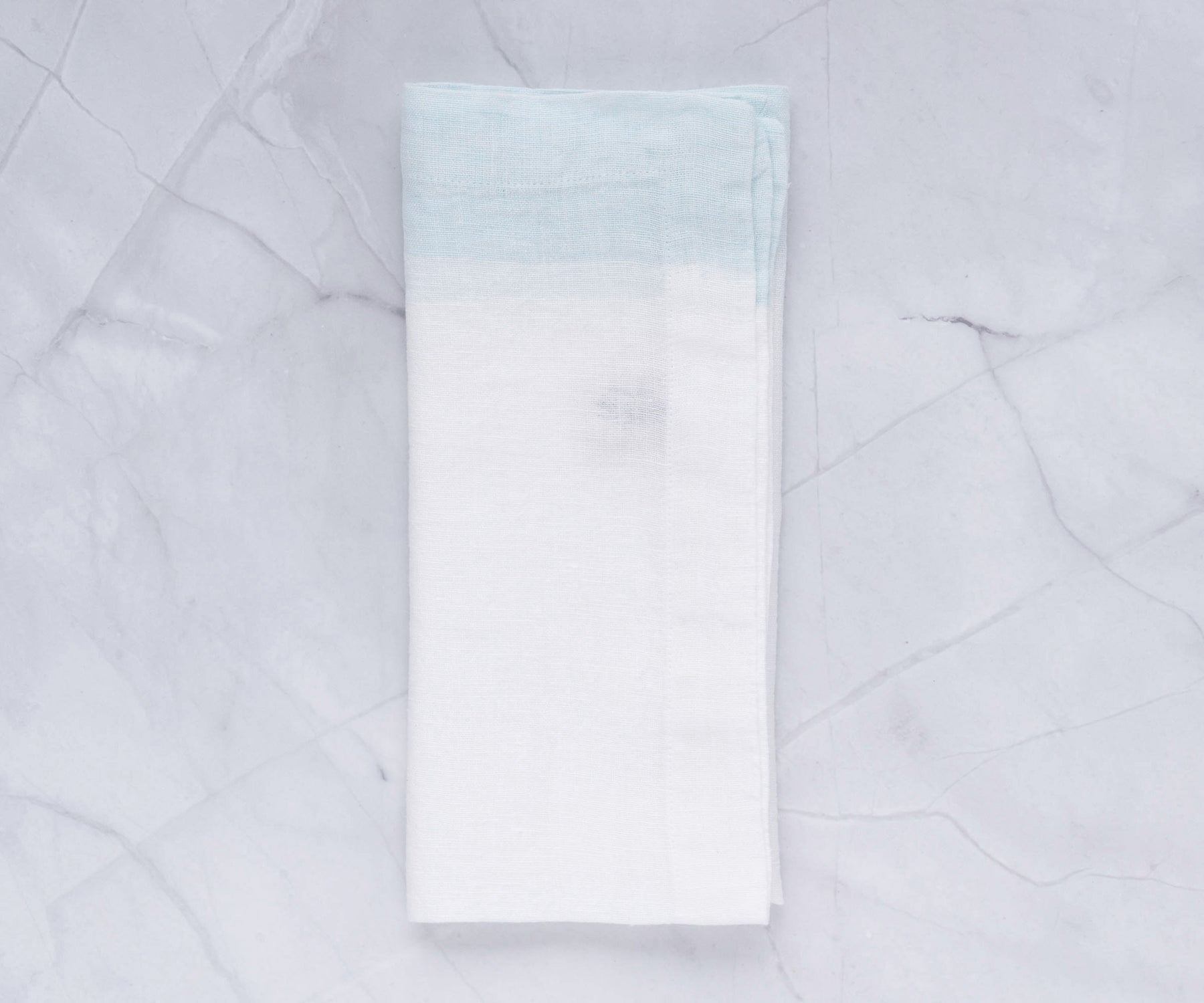 Wedding napkin folds demonstrated on a pristine white napkin