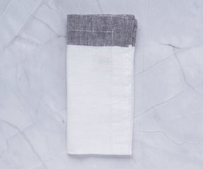 Pile of neatly stacked cloth dinner napkins in soft colors