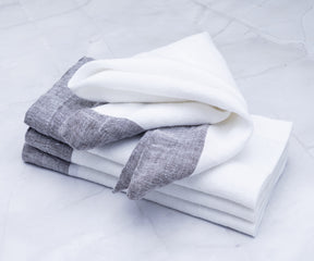 A collection of white cloth napkins for a formal dining setup