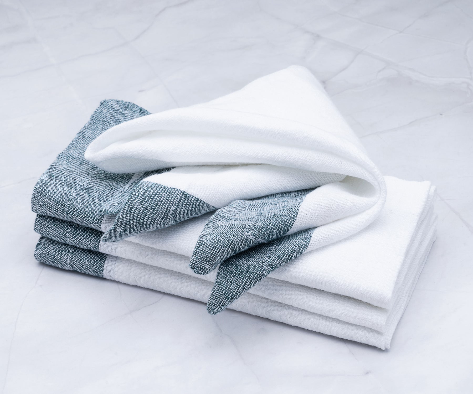 I have a set of gray napkins, perfect for dinner. These cloth napkins are made of linen, and I also have white linen napkins available.Explore creative linen napkin folds to elevate the presentation of your table setting.